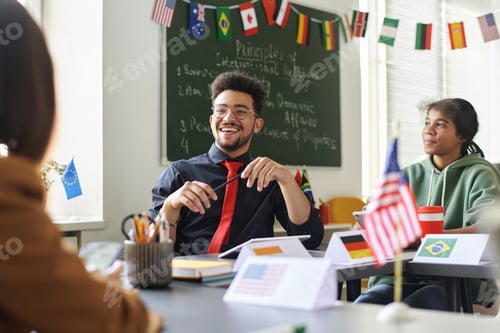 Preview: Smiling Teacher Talking to Students at Lesson