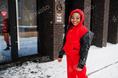 Preview: African american woman in red hoodie enjoy winter day.