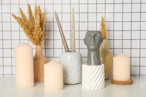 Preview: Candles, vases and figurine on light background