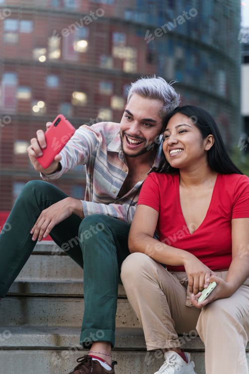 Preview: Latin American friends taking selfies sharing social media content on smart phone