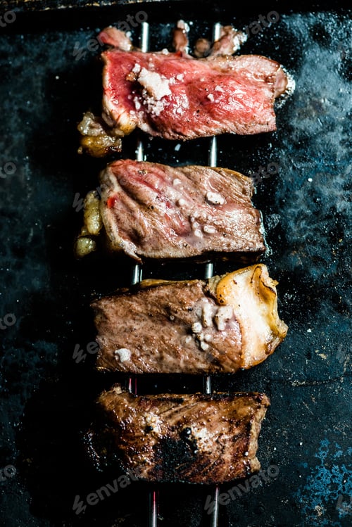 Preview: Vertical shot of delicious meat in the process of making a barbecue