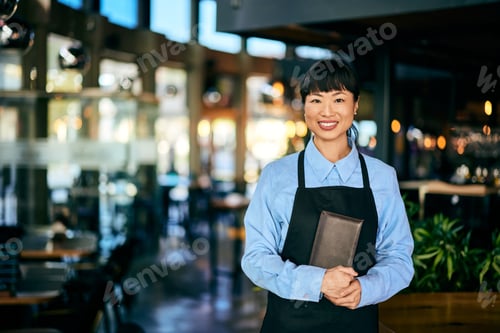 Preview: Portrait of a natural beauty Asian woman, working as a waitress, holding a bill case.