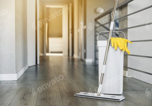 Preview: Cleaning supplies: mop, gloves, bucket with wringer on wooden laminate floor