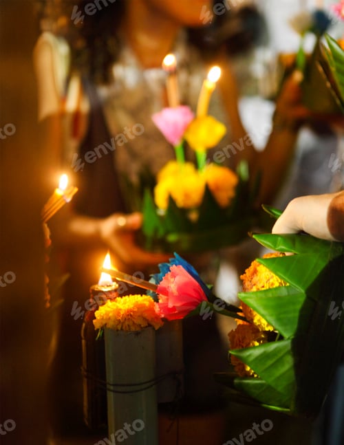 Preview: Woman holding boat with candles and flowers are given for Thailands traditional Loy Krathong