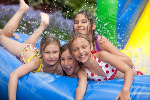 Preview: Happy Young Girls Playing in Inflatable Pool Outdoors