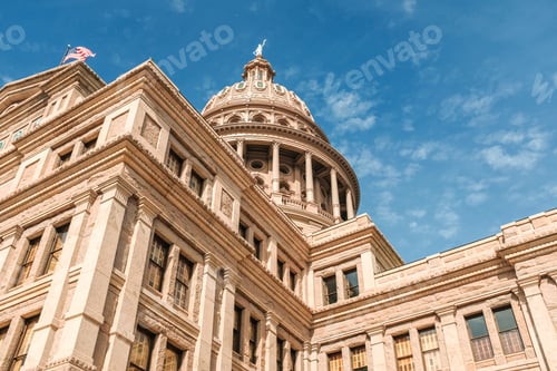 Preview: Low angle shot of Texas Capitol building under a blue beautiful sky. Austin city, Texas