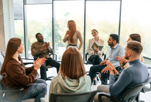 Preview: Indoors at daytime. Group of people are having therapy meeting together