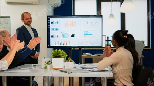 Preview: Smiling audience applauding at a business seminar