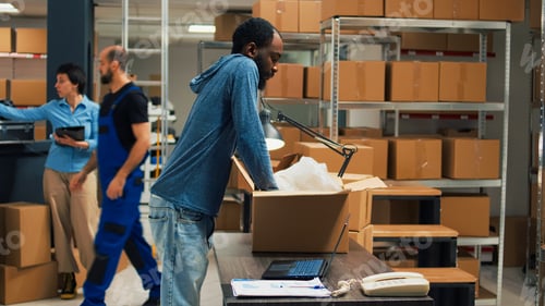 Preview: African american owner taking products from storage racks