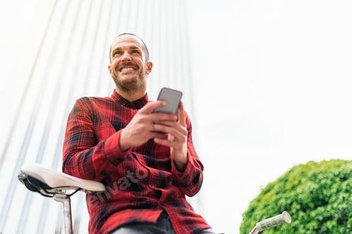 Preview: Young man with mobile phone and fixed gear bicycle.