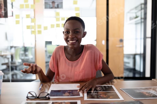 Preview: Happy african american businesswoman sitting at desk having video call conversation gesturing