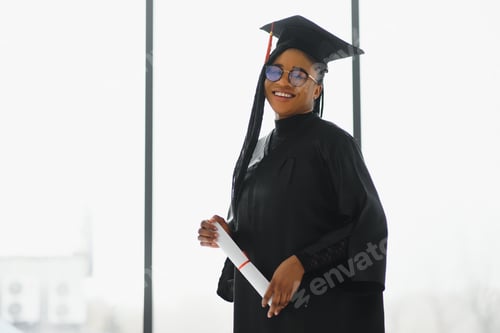 Preview: happy african american female student with diploma at graduation