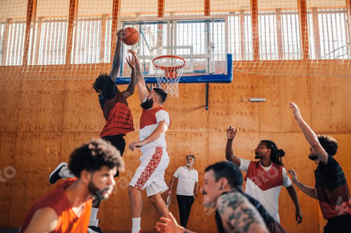 Preview: Interracial basketball player dunking the ball on his training.