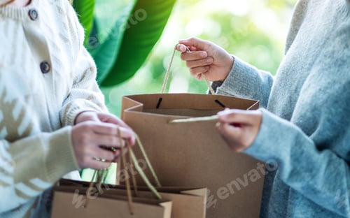 Preview: Women opening and looking at shopping bags together