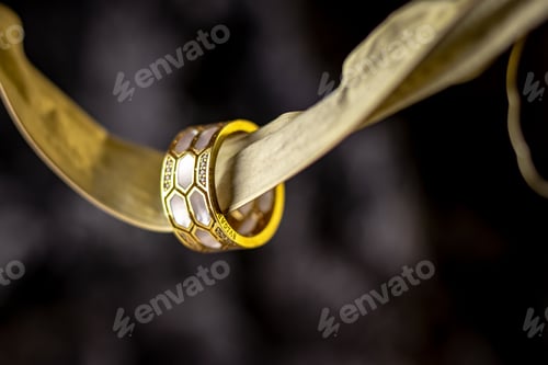 Preview: Closeup of a golden ring on a cloth