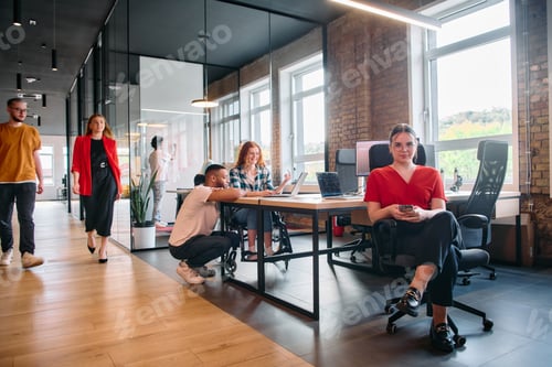 Preview: A diverse group of business professionals collaborates in a modern startup coworking center