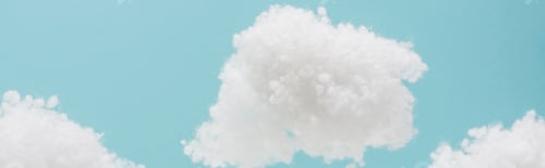 Preview: white fluffy clouds made of cotton wool isolated on blue background, panoramic shot