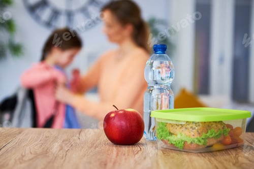 Preview: Healthy school lunch box with sandwich and fresh vegetables