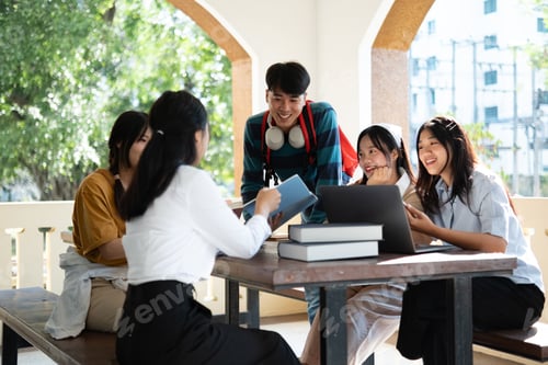 Preview: Group of students studying on campus outdoors