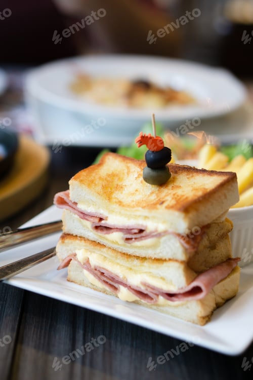 Preview: Close-up of sandwich ham cheese served with BBQ Pork Ribs and pasta cheese on table.