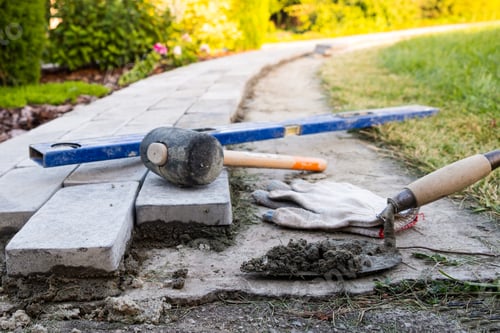 Preview: Laying paving stones on cement mortar. Laying a garden path made of tiles. Self-laying of concrete