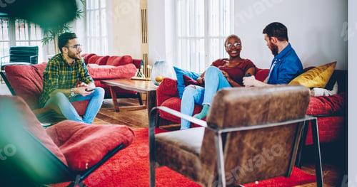 Preview: Diverse hipster guys communicating while recreating in hostel togetherness