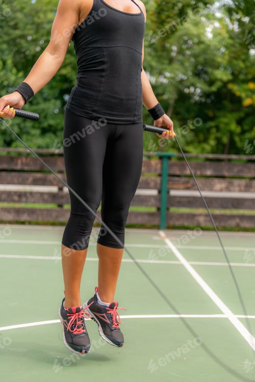 Preview: A woman enjoying a dynamic outdoor jump rope workout, promoting a healthy and active lifestyle