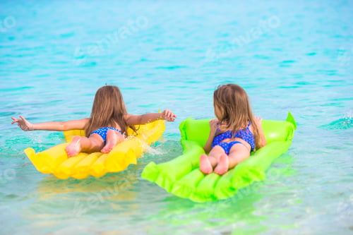 Preview: Adorable little girl on air inflatable mattress in the sea