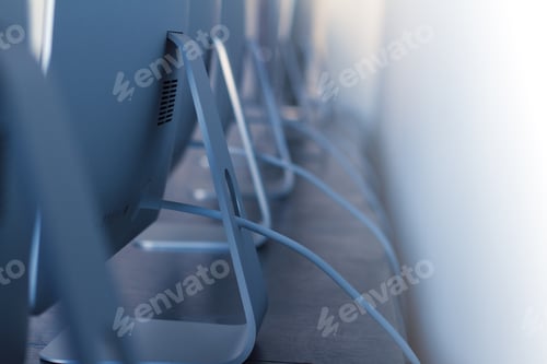 Preview: row of desktop computers with cables on desk