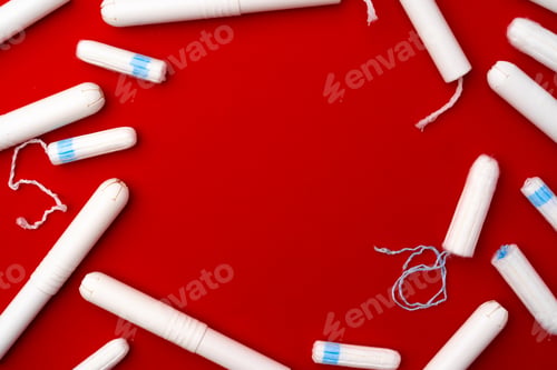 Preview: Pile of female tampons on red background