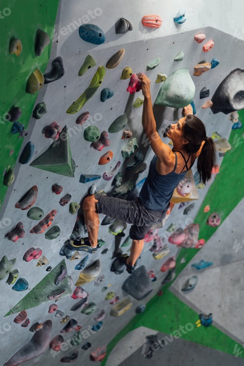 Preview: girl is climbing on the wall in the training room