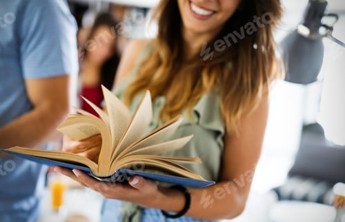 Preview: Group of happy young students having fun while studying together for exams