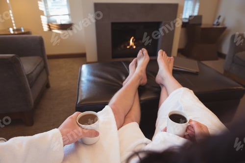 Preview: Couple relaxing while having coffee in the living room