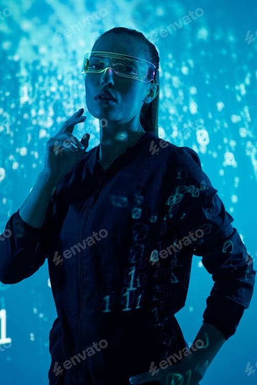 Preview: Confident young woman in futuristic glasses standing against colorful background
