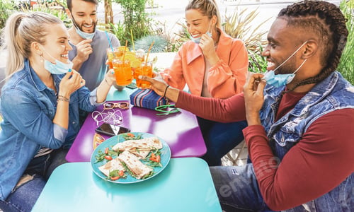 Preview: Friends drinking coktail and eating snack tapas in a restaurant bar