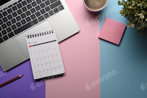 Preview: Above view computer laptop, calendar, sticky note and coffee cup on purple background.