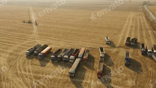 Preview: Top view of grain trucks on the field.