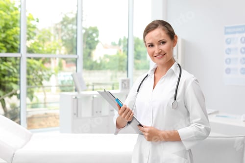 Preview: Female doctor with clipboard in hospital. Patient attendance
