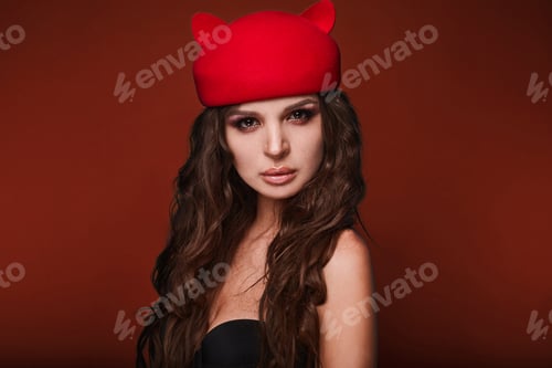 Preview: Beauty Portrait Of Young Swag Sexy Woman With Curly Long Hair In Cat Hat On Red Background In