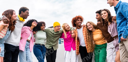 Preview: Happy playful multiethnic group of young friends bonding outdoors