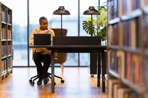 Preview: Student studying at a quiet library