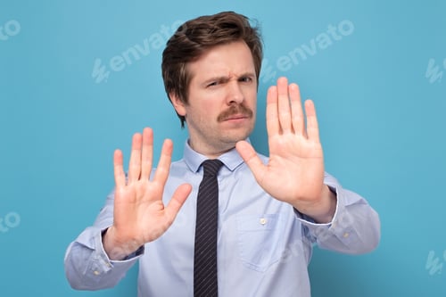 Preview: man with mustache moving away hands palms showing refusal and denial gesture