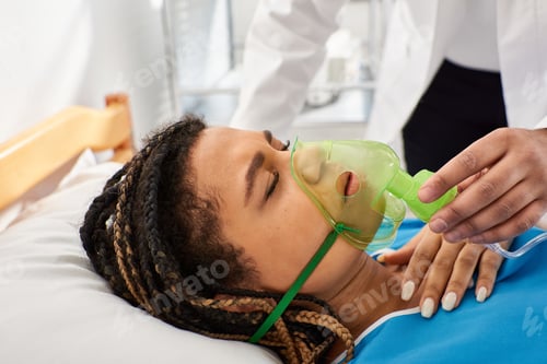 Preview: cropped view of doctor comforting ill african american woman lying in hospital bed with oxygen mask