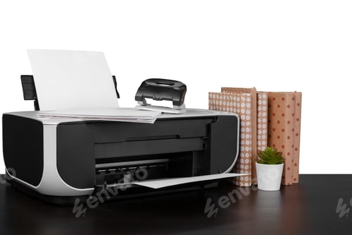 Preview: Printer and stack of books on black table against white background