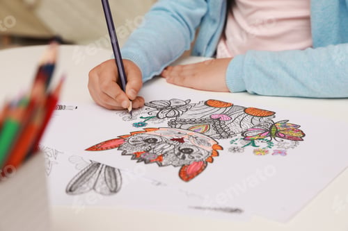 Preview: Little girl coloring antistress page at table, closeup