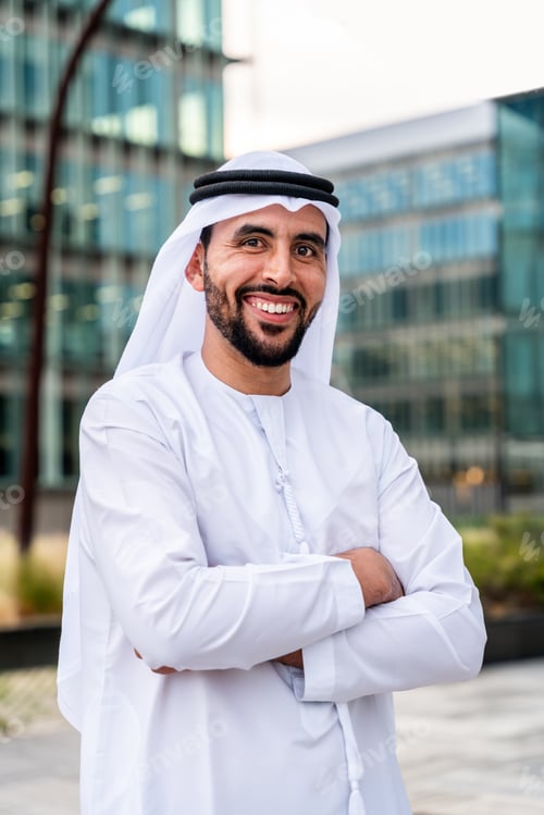 Preview: Arab middle-eastern man wearing emirati kandora traditional clothing in the city