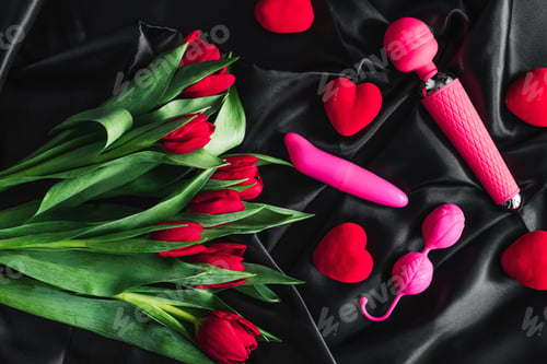 Preview: Various sex toys set on a black background. Advertising a sex shop. The view from the top.Tulips