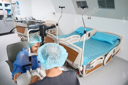 Preview: Ophthalmologist examining the eyeball of patient after surgery