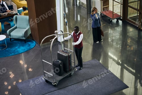 Preview: Doorman carrying the trolley with luggage