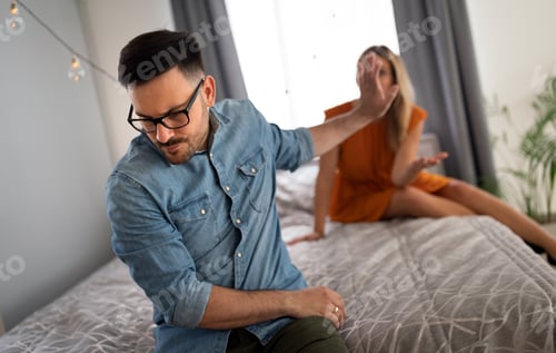 Preview: Upset Couple Arguing in Bedroom at Home